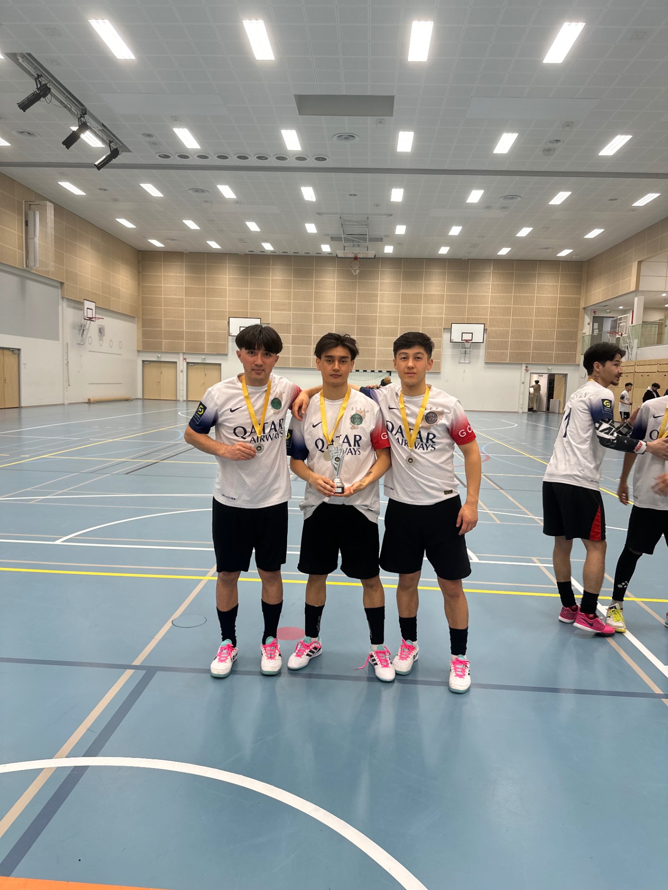 Three Shirdaghian FC players with medals and a trophy
