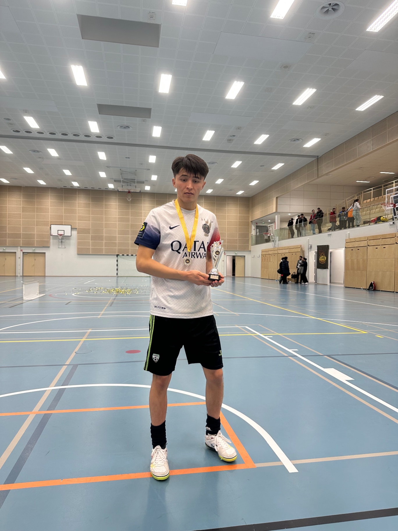Shirdaghian FC player with medal and trophy on the court