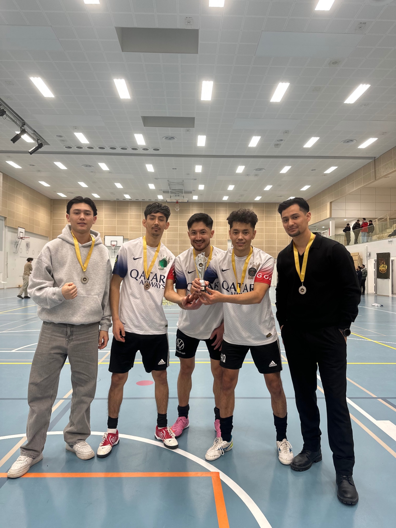 Five Shirdaghian FC teammates with medals and the trophy