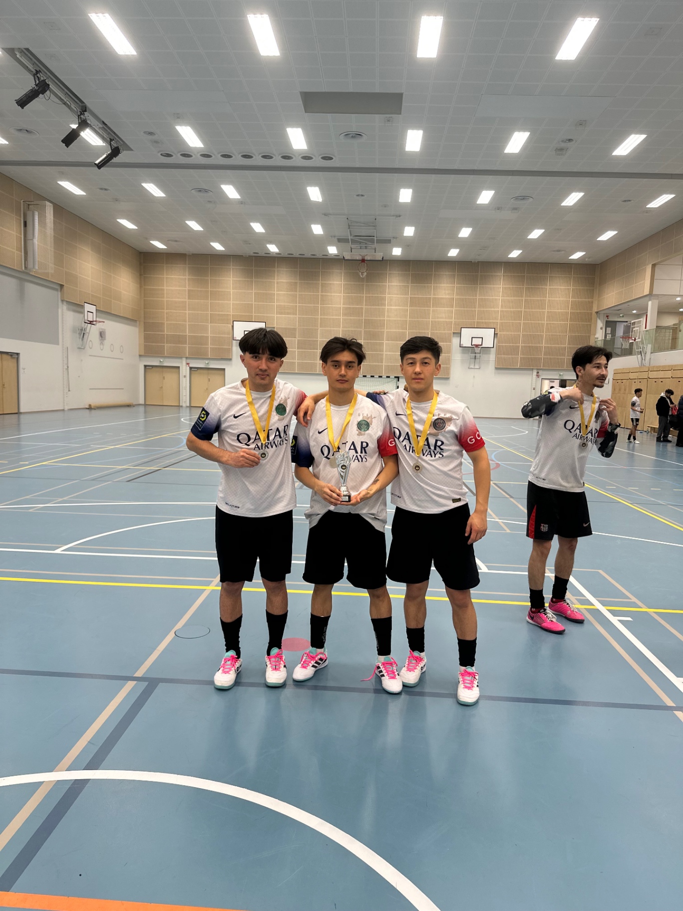 Three Shirdaghian FC teammates with medals and the trophy